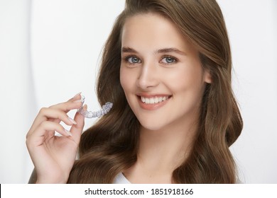 Pretty Young Female With Perfect Smile Holding Mouth Guard, Beautiful Woman Smiling To Camera Isolated On White, Stomatology Concept