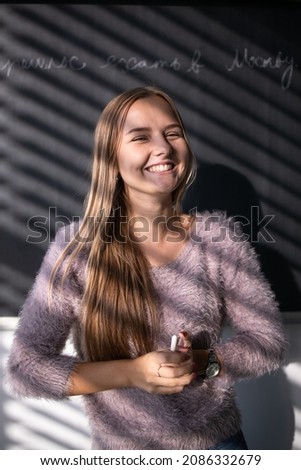 Pretty, young female studentteacher in front of a blackboard during math class Stock photo © 
