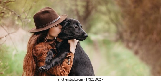 Pretty Young Girl Holding Her Puppy Retriever Dog In The Nature, Sharing A Hug, Cuddling, Kissing. Animal Best Friend, Lovely Friendship