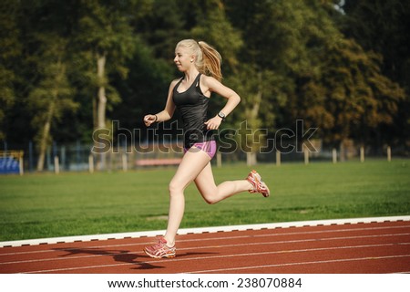 A pretty young girl running and stretching on the runway