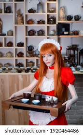 Pretty Young Girl Servant Costume Portrait Dressed In Red Role Play In The Shop Serving Tea