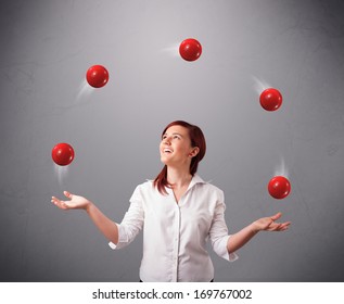 pretty young girl standing and juggling with red balls