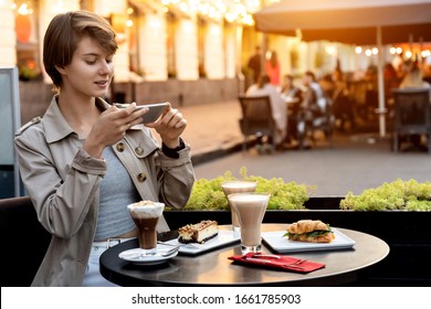 Pretty Young Girl Teen Blogger Cafe Table Modern Smart Phone Take Post Photo Food Coffee Dessert Instagram Feed Shoot Vlog For Restaurant Review Camera Romantic Cafeteria Terrace Background Copyspace.