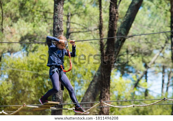 pretty young girl in a\
tree climbing park