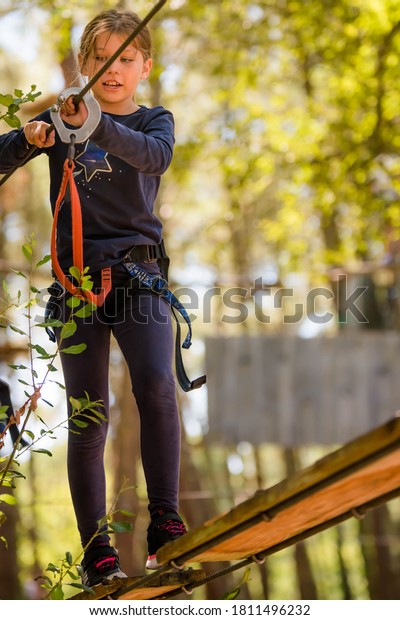 pretty young girl in a
tree climbing park