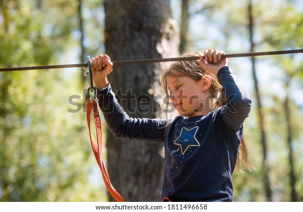 pretty young girl in a\
tree climbing park