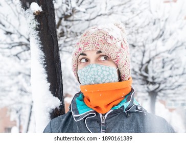 
Pretty And Young Girl With Woolen Cap And Mask In A Winter Scene