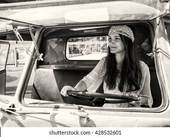 Pretty Young Hippie Woman Driving Her Vintage Oldtimer Car (black And White Toned Image, Retro Style) 