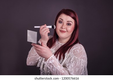 Pretty Young Lady Applying Blush With Makeup Brush Holding Compact Mirror