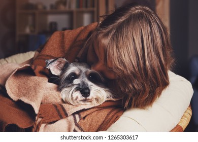 pretty young owner cuddling with her cute dog - Powered by Shutterstock