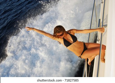 Pretty Young Slim Sexy Brunette Woman In Sunglasses And Black Stylish Bikini On Private Speed-boat Yacht On Vacation In Summer Time Smiling And Touch Her Hair, Sailing In Mediterranean Sea