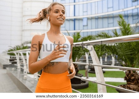 pretty young smiling woman jogger running doing sports in the morning in stylish sport outfit sportswear, skinny strong body, healthy fit lifestyle, tropical vacation trip