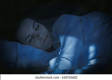 Pretty Young Woman In Bed Peacefully Sleeping At Night