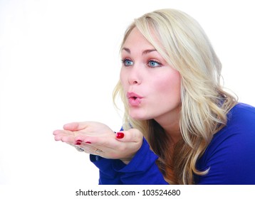 A pretty young woman blowing with open palms, isolated on a white background.