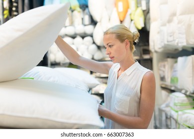 Pretty, Young Woman Choosing The Right Item For Her Apartment In A Modern Home Decor Furnishings Store. Shopping In Retail Store.