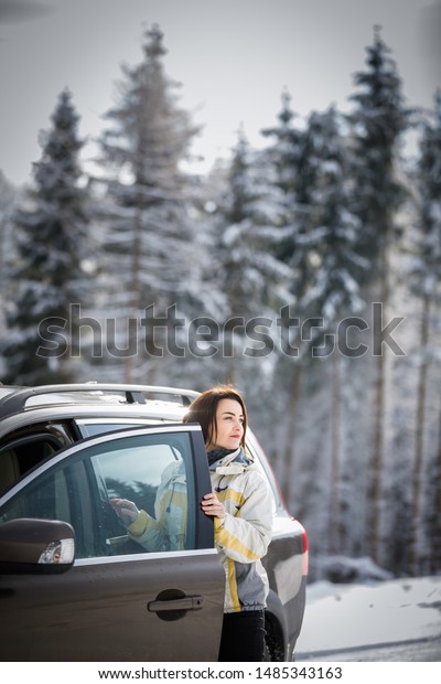 Pretty, young woman  driving a car -Invitation\
to travel. Car rental or\
vacation.