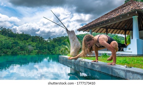 A Pretty Young Woman During Advanced Yoga Practice Next To The Swimming Pool In A Peaceful Holidays Resort Near Unawatuna, Sri Lanka