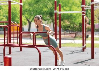 Pretty young woman exercising on sport ground - Powered by Shutterstock