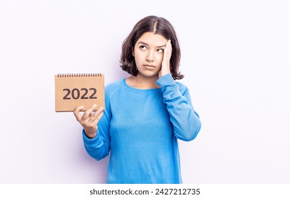 pretty young woman feeling bored, frustrated and sleepy after a tiresome. 2022 calendar concept