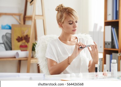 Pretty Young Woman Filing Her Nails