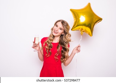 Pretty Young Woman With Gold Star Shaped Balloon Smiling And Drinking Champagne Over White Background