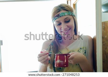 Pretty young woman holding a pot of freshly made coffee 