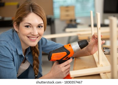 Pretty Young Woman Holding Screwdriver