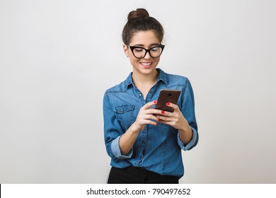 Pretty Young Woman Holding Smart Phone, Using Device, Wearing Stylish Glasses, Smiling, Isolated On White Background, Denim Shirt