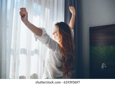 Pretty Young Woman In Modern Apartment Stretching After Wake Up