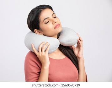 Pretty Young Woman With Neck Pillow On White.