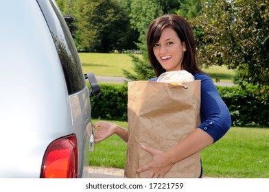 Pretty Young Woman Opening The Tailgate Of Her Sport Utility Truck