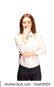 Pretty Young Woman In Pants And White Blouse Yawning. Contagious Yawning. Business Woman Tired. Girl Bored. Professional Fashion Model In The Studio Wants To Sleep. Hard Day.