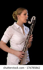 Pretty young woman playing bass clarinet, Studio Shot
