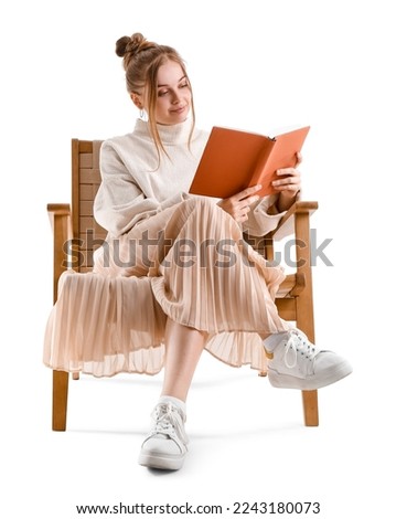 Pretty young woman reading book in armchair on white background