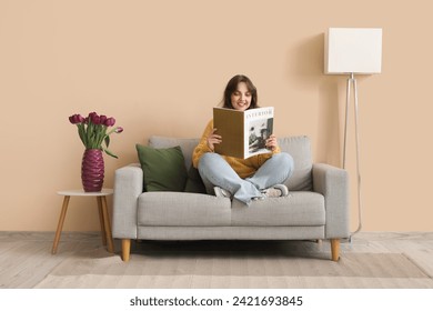 Pretty young woman reading magazine and vase with bouquet of beautiful purple tulips at home - Powered by Shutterstock