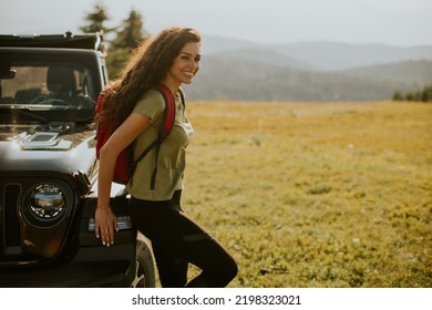 Pretty Young Woman Relaxing On A Terrain Vehicle Hood At Countryside