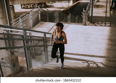 Pretty young woman running in the urban environment