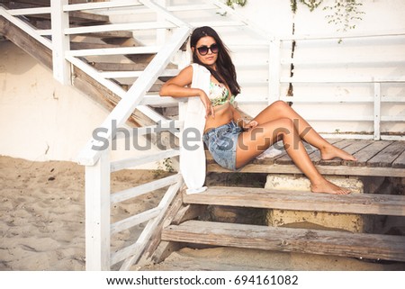 Similar – Young surfer woman with top and bikini kissing surfboard