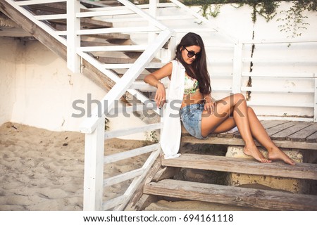 Similar – Young surfer woman with top and bikini kissing surfboard