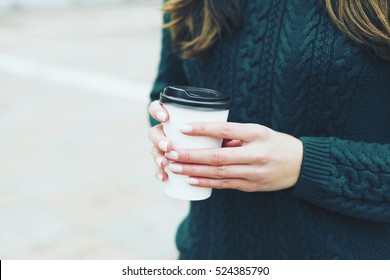 Pretty Young Woman In Stylish Green Sweater Holding Cup In Hands. Warm Soft Cozy Image. Details. Drinking Take Away Coffee. Breakfast On The Go. Instagram Style Toned Image