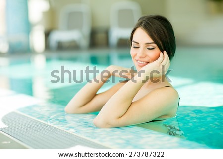 Pretty young woman in the swimming pool