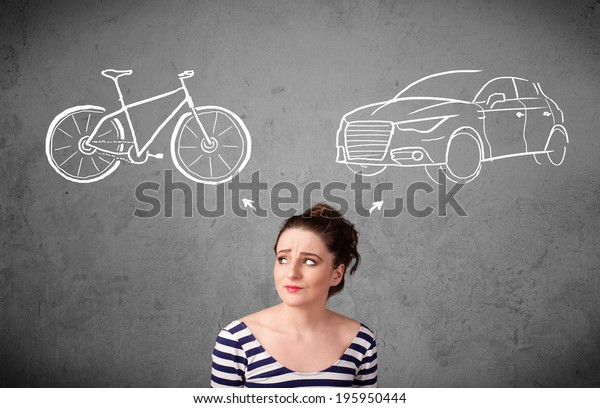 Pretty young woman taking a decision between bicycle\
and car