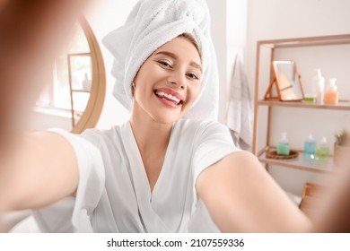 Pretty young woman taking selfie in bathroom after morning shower - Powered by Shutterstock