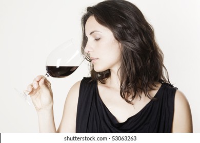 Pretty Young Woman Tasting Red Wine