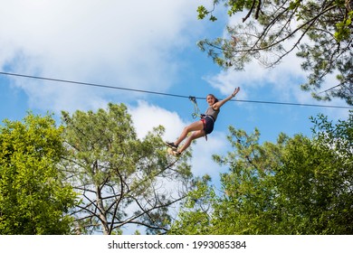 Pretty Young Woman In A Tree Climbing Park