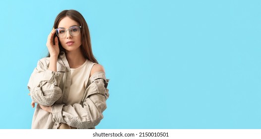 Pretty Young Woman Wearing Eyeglasses On Light Blue Background With Space For Text