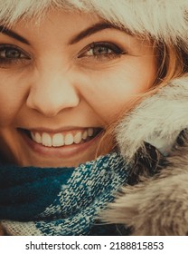 Pretty Young Woman Wearing Warm Accessories During Winter Time. Female Having Grey Warm Hat Made Of Light Fur And Blue Scarf.