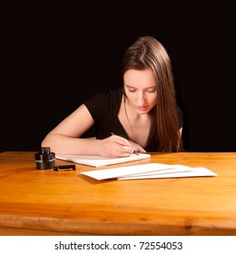 Pretty Young Woman Writing A Letter At An Old Table