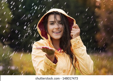 Pretty Young Woman In Yellow Raincoat