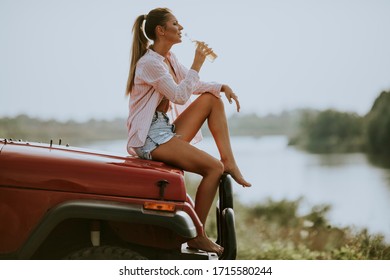 Pretty Young Women Drinking Cider On The Vehicle At The Lakeside